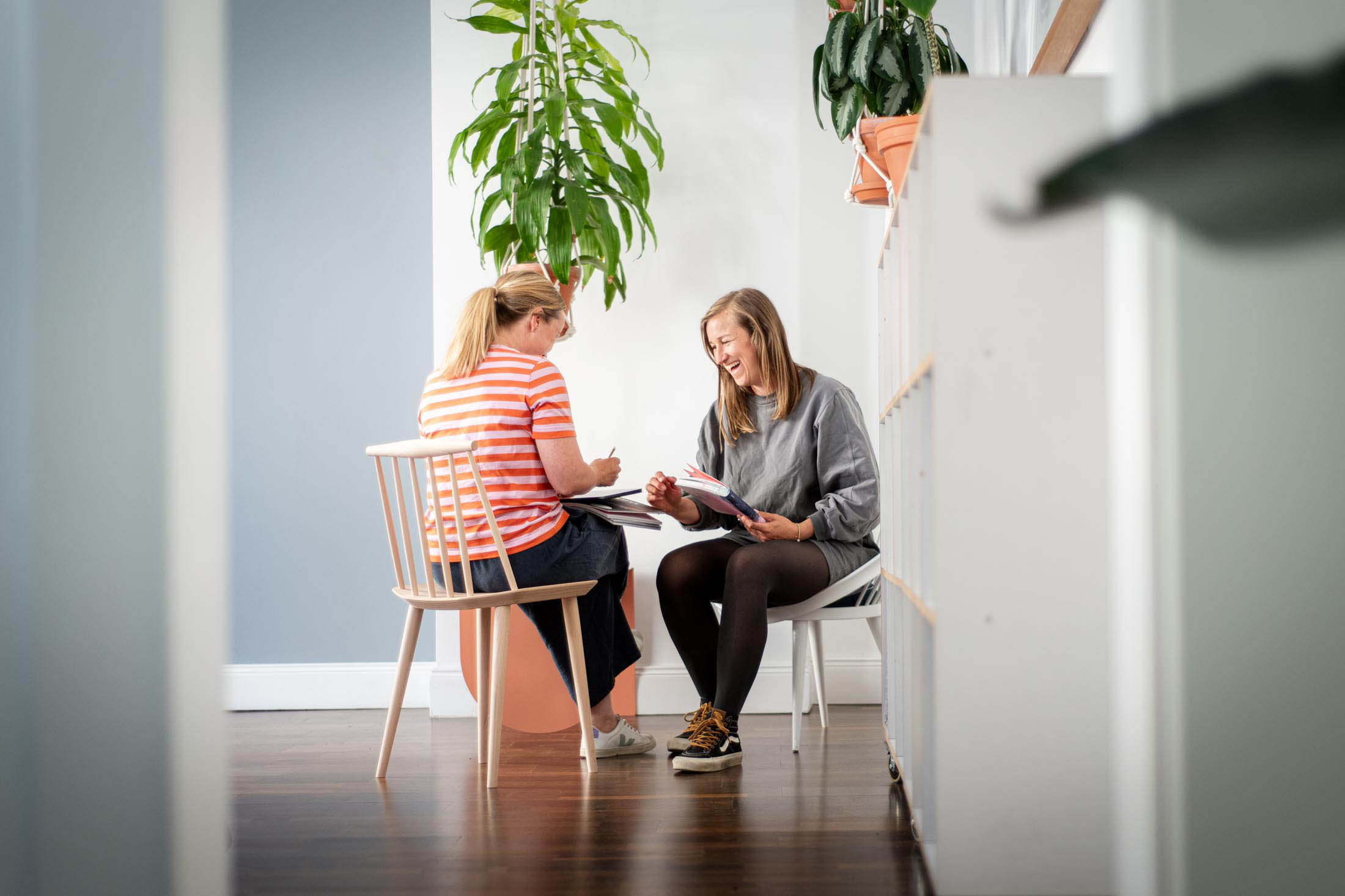 Zwei Personen im Gespräch an kleinem Tisch im Büro